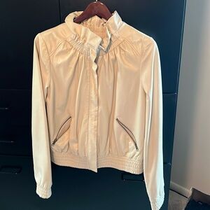 Leather jacket. Light beige, zipper closure, ruffled neckline. Side pockets.
